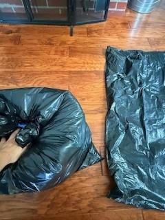 After inserting pillows in the first garbage bag, squeeze out excess air before inserting it in the second bag and then into the fireplace to air seal the flue