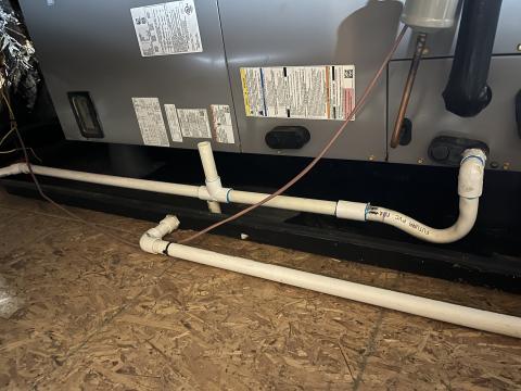This air conditioner is located in an unconditioned attic and has a condensate line that is uninsulated.