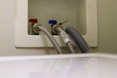When installing a new clothes washer, connect the hot, cold, and drain hoses; the drain hose should extend less than 6 inches into the drain to allow an air gap so that water doesn’t get siphoned back into the washing machine.