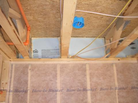 Insert rigid blocking pieces into each joist bay and fasten with caulk or nails