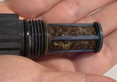 This water filter from a tankless water heater is very clogged with debris