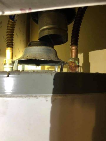 This gas water heater flue pipe is disconnected; this is a dangerous situation allowing carbon monoxide and other combustion emissions to escape into the home; call a plumber to make repairs as soon as possible 