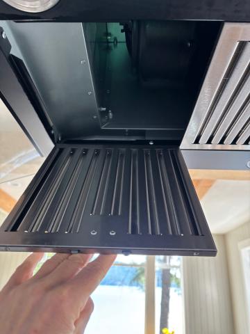 The down draft range hood fan has filters located under the hood.