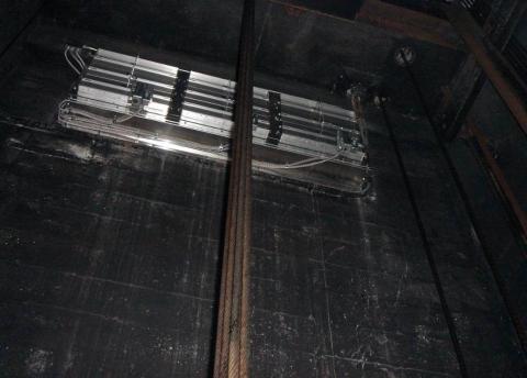 An elevator shaft vent with a motorized damper in a multistory multifamily building provides smoke and hot gas control in an elevator shaft during fire events; during normal operation the damper remains closed to reduce energy loss.