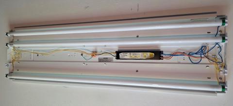 The electronic ballast (black box) in this linear fluorescent fixture should be removed when replacing the fluorescent tubes with Type B or C linear LEDs