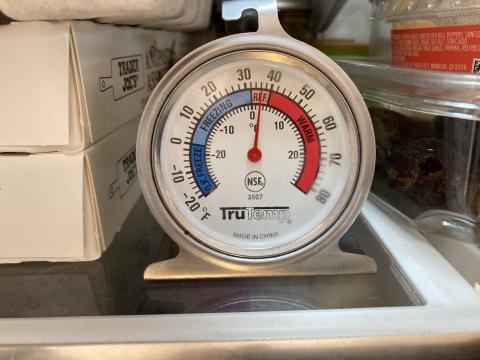 This is a typical refrigerator thermometer showing ideal temperature ranges for both refrigerators and freezers