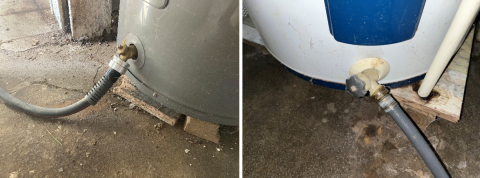 A standard garden hose is connected to the drain valve to drain the water heater tank.