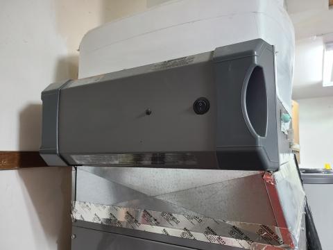 This HVAC air filter slot is covered with a door that is held in place with spring clips and tabs.