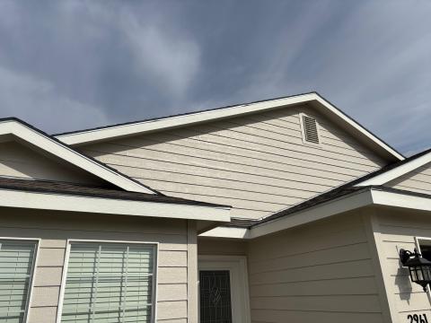The steel drip edge flashing is easy to see above the fascia and just below the roofing along all of the roof edges of this home.