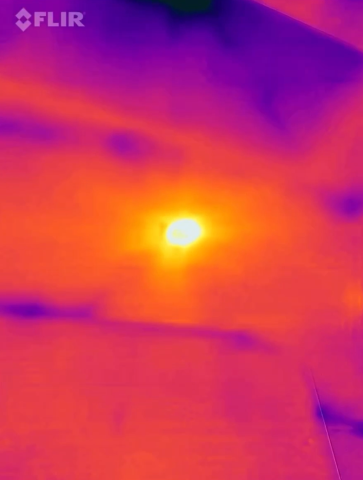 This IR camera image shows a recessed can light that is well sealed and insulated.