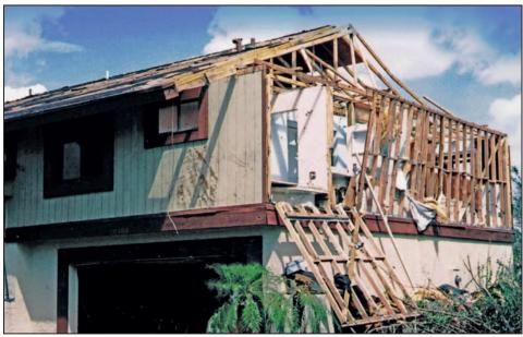Failure at a gable end of a home under hurricane force wind conditions due to improper continuous load path design.