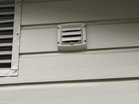 This exterior vent has a louvered flap that opens when the bathroom exhaust fan is running and air is being exhausted outside