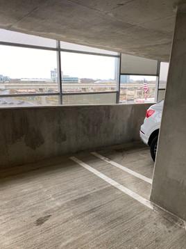 This shared parking garage in a multistory multifamily building is open to the exterior, allowing for natural air changes to control airborne contaminant concentration.