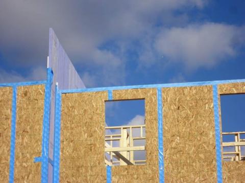 The party wall interfaces of this multifamily building are sealed with air-sealing tape