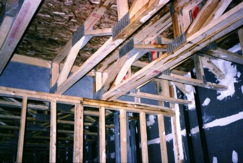Where the interior wall intersects the corridor wall in this multifamily building, the first intersecting wall stud is sealed to the corridor wall along both sides; other seams and penetrations in the exterior wall are also sealed