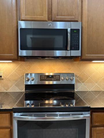 This microwave oven is located over the stove and has an exhaust fan underneath it