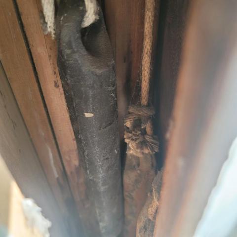 Old window weights can be removed and the cavities on each side of the window can be filled in with rigid foam, then new jamb liners and spring balance hardware can be installed.