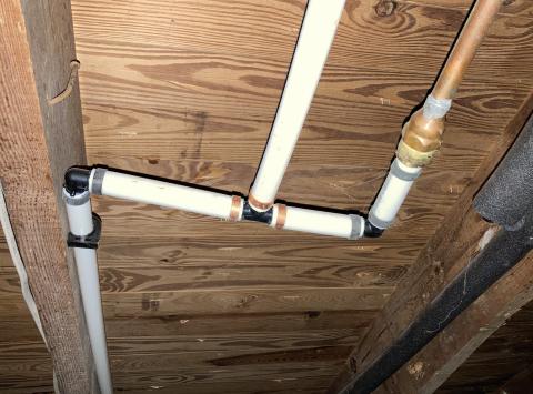 When looking for plumbing pipes to find floor penetrations, remember that plumbing pipe may consist of several different materials, such as PEX (white pipes on left), copper (right), plastic, or insulated with foam (gray, far right).