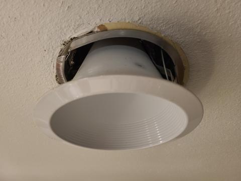 Pull the trim of the recessed ceiling fixture kit down from the ceiling 