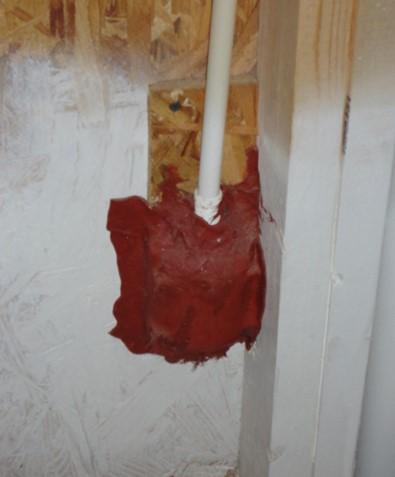 A fire-rated sealant "putty pad" is used to air seal an electrical outlet box