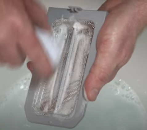 Clean the air filter of your tankless water heater with soapy water and a soft bristled brush.