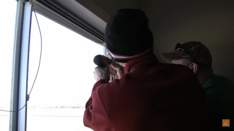 Screw the storm window frame into the existing window’s wood casing to secure it.