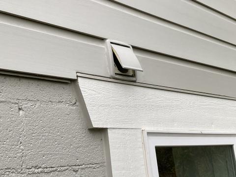 This exterior vent has a single flap that opens when the bathroom exhaust fan is running and air is being exhausted outside