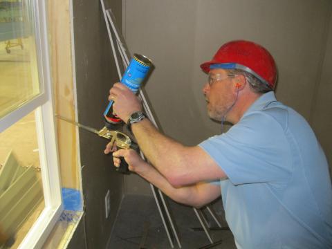 The rough opening around this window is air sealed and insulated with nonexpanding spray foam.