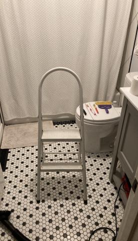 Use a step ladder to access the bathroom exhaust fan