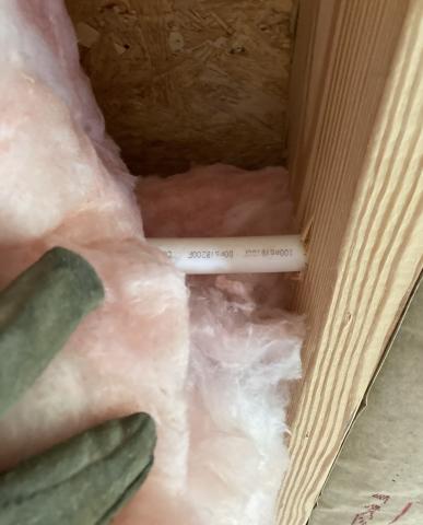 Pipes and wires in a crawlspace or basement are often concealed by insulation which can be pulled back while wearing gloves, long sleeves, glasses, and a well-fitting dust mask.