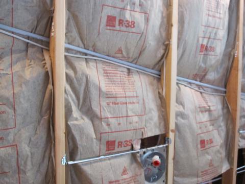 Faced fiberglass batt insulation incorrectly installed