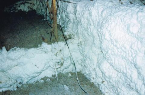 The attic duct chase insulated and sealed to the attic floor with spray foam