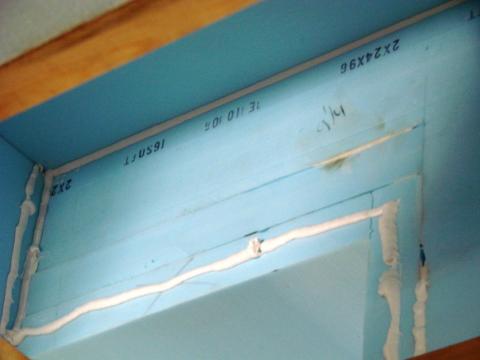 Second layer of rigid insulation is adhered with foam