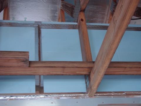 Seal bottom layer of rigid insulation with adhesive, tape and nails
