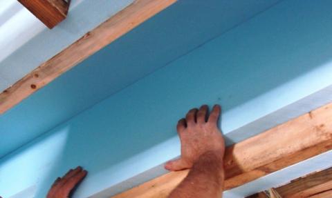 A second layer of rigid insulation is installed over the 2 in. by 4 in. retaining strip
