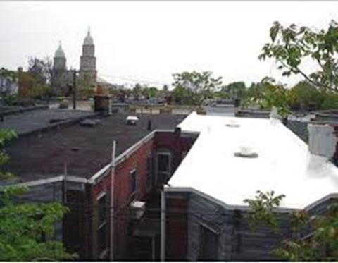 The white TPO membrane roof on the row house on the right performs extremely well at reflecting solar energy and maintaining cool surface temperatures while the black EPDM membrane roof on the left heats up rapidly in the sunlight