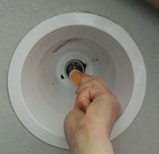 Remove the bulb from the old recessed can light and test the voltage before inserting a new LED retrofit trim kit