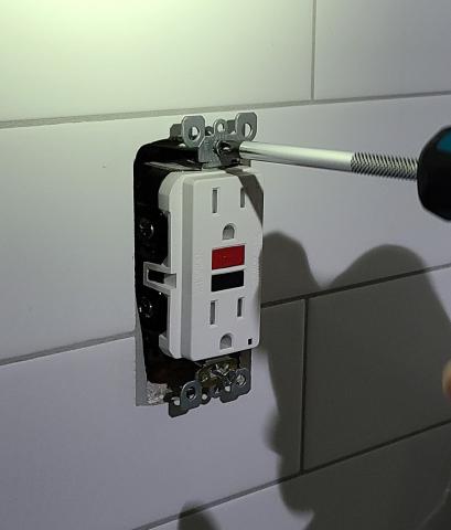 Unscrew the screws on the outlet or switch to take it out of the electrical box to access and air seal any holes in the back of the box.
