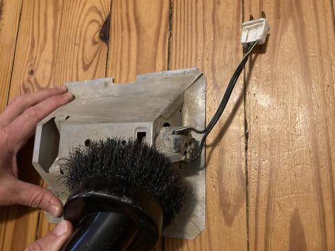 Use a vacuum brush attachment or a soft dry cloth to clean the light fixture of the exhaust fan/light
