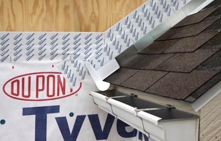 Apply self-adhesive flashing over top edge of the wall flashing, diverter, and housewrap