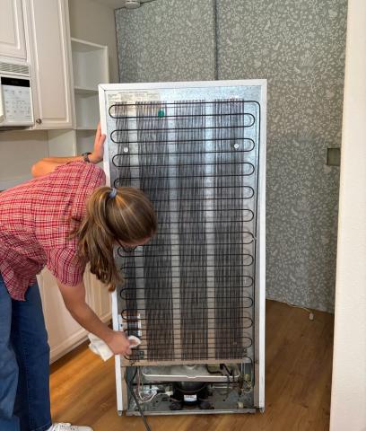 Wipe refrigerator condenser coils with a slightly damp rag to remove stubborn dust from the coils. 