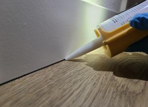 The trim-to-flooring seam can be caulked to provide an air seal at the base of the walls.