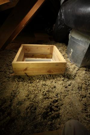 Right - A wood dam was constructed to hold back the attic floor insulation