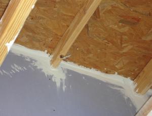 Fire-rated sealants or a fire-rated assembly air seal the tops and bottoms of the demising walls between two units in a multifamily building