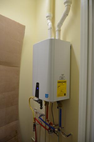 A tankless gas water heater provides continual hot water.