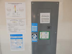Home performance program labels are displayed on the electric panel showing the certifications this home has receivied, including ENERGY STAR Certified Home, the EPA Indoor airPLUS, and the Home Energy Rating System (HERS) score.