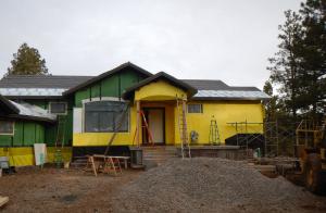 Over the coated sheathing air barrier, the builder installed a continuous layer of 2-inch rigid foam and then covered this with a yellow mesh rain screen layer. 