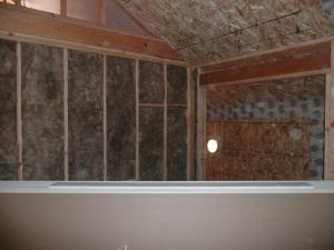 Extra-wide air sealing tape seals seam where the structural insulated panels (SIPs) that form the roof and walls meet. 