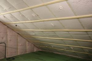 Underneath the roof sheathing and two exterior layers of rigid foam, the builder stapled netting to the underside of the rafters and filled the roof cavities of the unvented attic with blown-in fiberglass insulation.