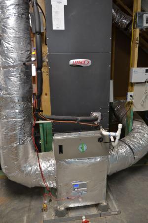 The high-efficiency air-to-air heat pump is set in an overflow pan with an emergency shut off sensor in case the condensate tube were to clog and cause condensate to fill up the pan.